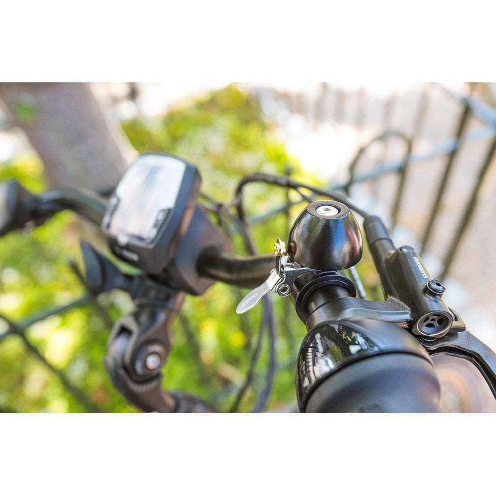 Zefal Classic Brass Bike Bell with loud sound and easy installation, mounted on a bicycle handlebar for cycling safety.