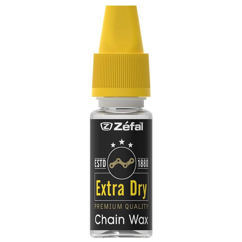 Zefal Extra Dry Chain Wax lubricant applied to bike chain for smooth gear shifts and drivetrain protection in a workshop setting.