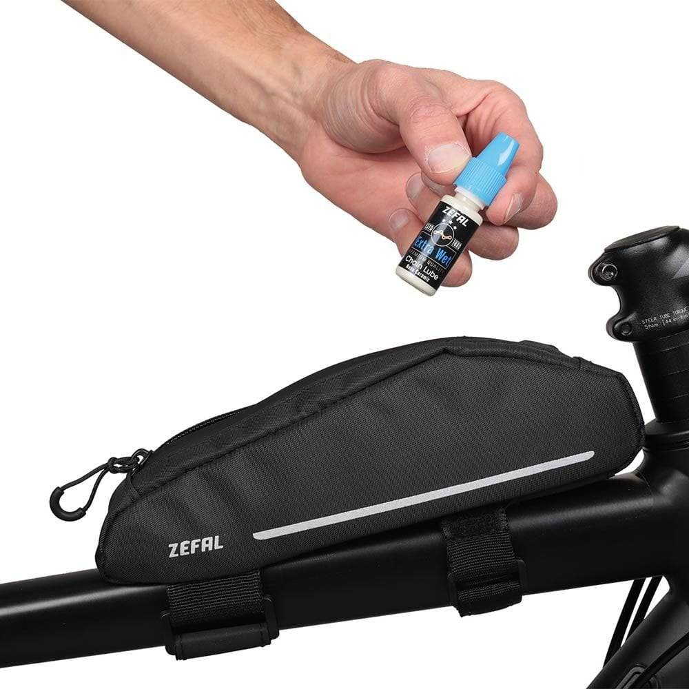 Zefal Extra Wet Lube ceramic bike chain lubricant for all weather conditions, shown in a workshop setting