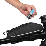 Zefal Extra Wet Lube ceramic bike chain lubricant for all weather conditions, shown in a workshop setting