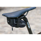 Zefal Z Light saddle pack with reflective stripes and light mount attached to a bike seat for convenient storage.