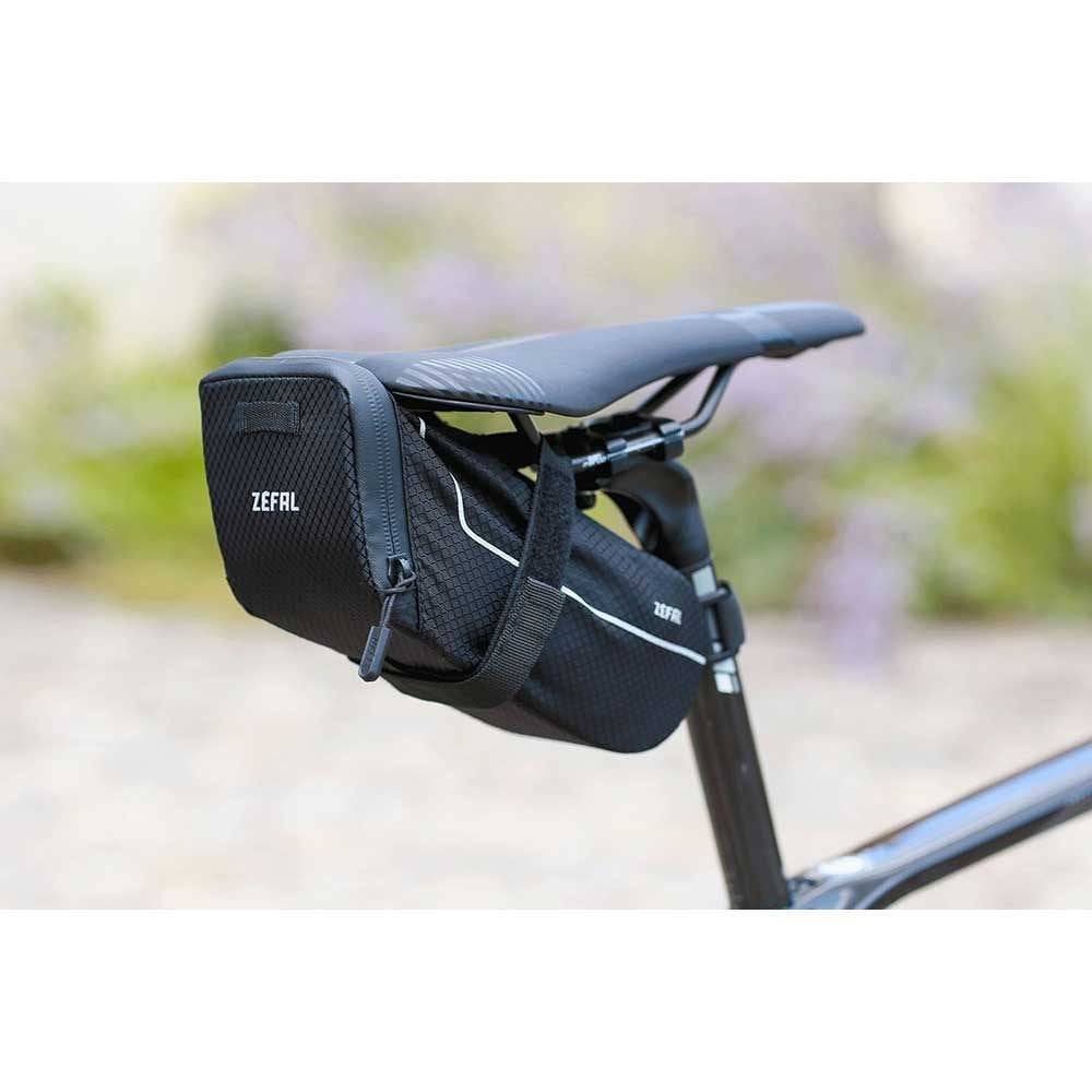 Zefal Z Light Saddle Pack with reflective stripes and light mount attached to a bike seat, designed for bike storage accessories.