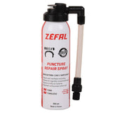 Zefal Puncture Repair Spray for bikes, showing a workshop scene with the spray can and bike tire repair tools.
