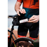 Zefal puncture repair spray in workshop setting, used for quick flat tire fixes and re-inflation on bikes.