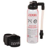 Zefal puncture repair spray for bikes, showing a workshop setting with spray can used for quick flat tire fixes and re-inflation.