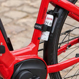 Zefal Puncture Repair Spray for bikes, showing a workshop setting with the spray can and bike tire repair tools.