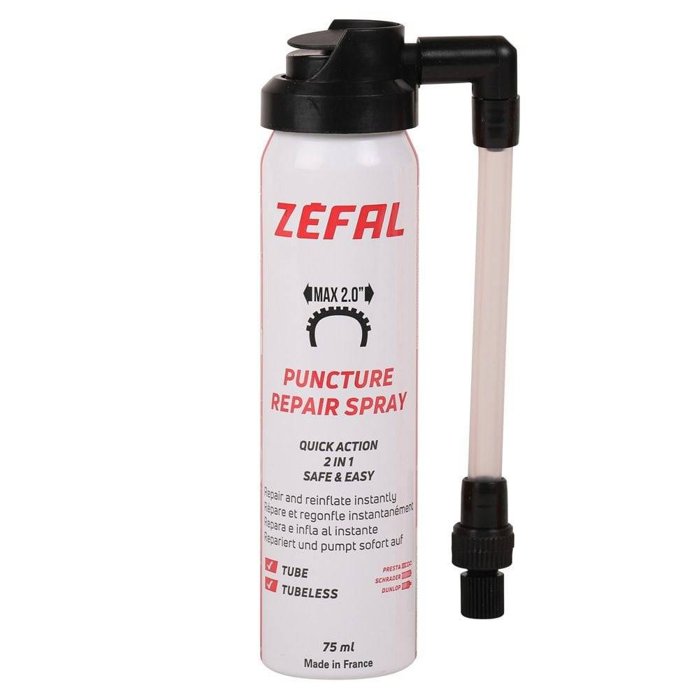 Zefal puncture repair spray for bikes, quick flat tire fix and re-inflation, in a workshop setting.