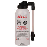 Zefal puncture repair spray for bikes, showing a workshop setting with spray can and bicycle tire being repaired.