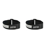 Zefal Doowah long trouser straps with reflective tape for visibility and security, attached to black clothing for cycling safety.
