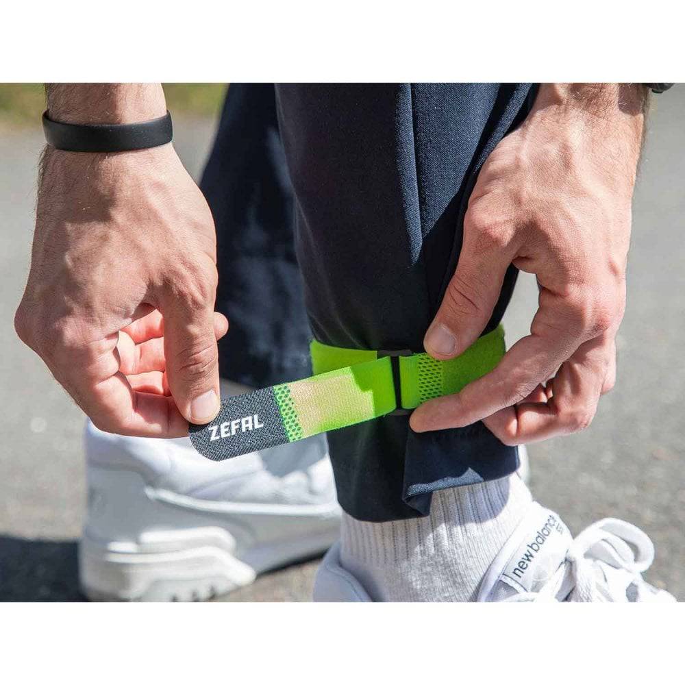 Zefal Doowah long trouser straps with reflective tape for visibility and security, worn over outdoor clothing.
