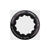 Shimano CS-R8000 lock ring and spacer for road bike drivetrain, genuine spare bike components, metal parts on a white background