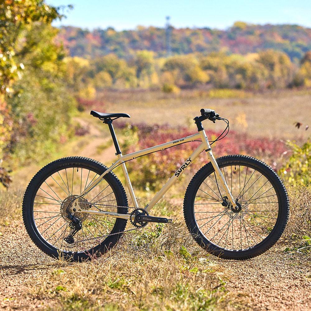 Surly Bridge Club 27.5 bike frame for touring and multi-surface riding, shown in a natural setting with detailed frame features