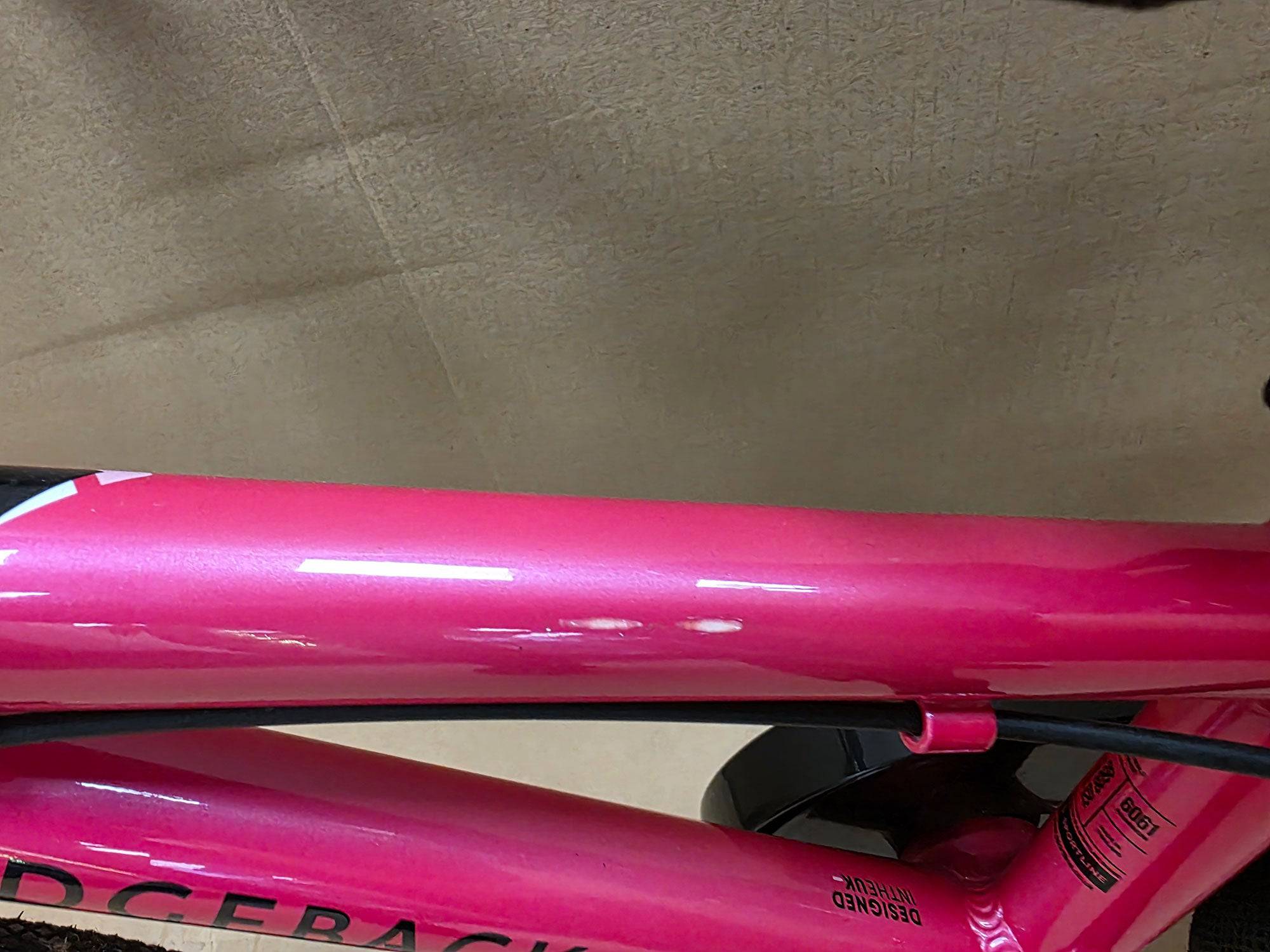 Pink Ridgeback Kids Dimension 14-inch ex-demo bike with training wheels, suitable for beginners and young riders.