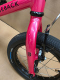 Pink Ridgeback Kids Dimension 14-inch beginner bicycle with training wheels, suitable for young children and new riders.