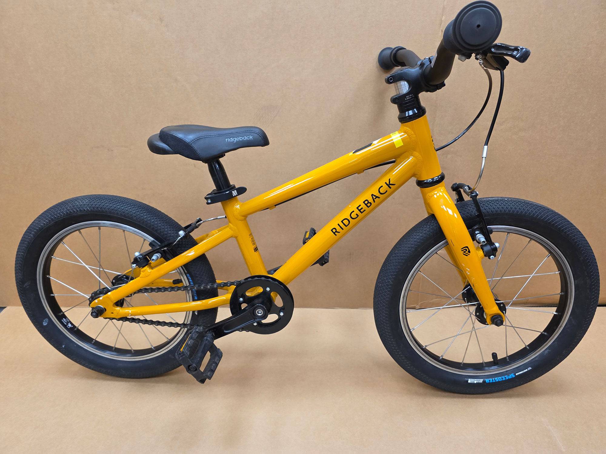Ridgeback Kids Dimension 16-inch children's bike with black frame and colorful accents, designed for young riders.