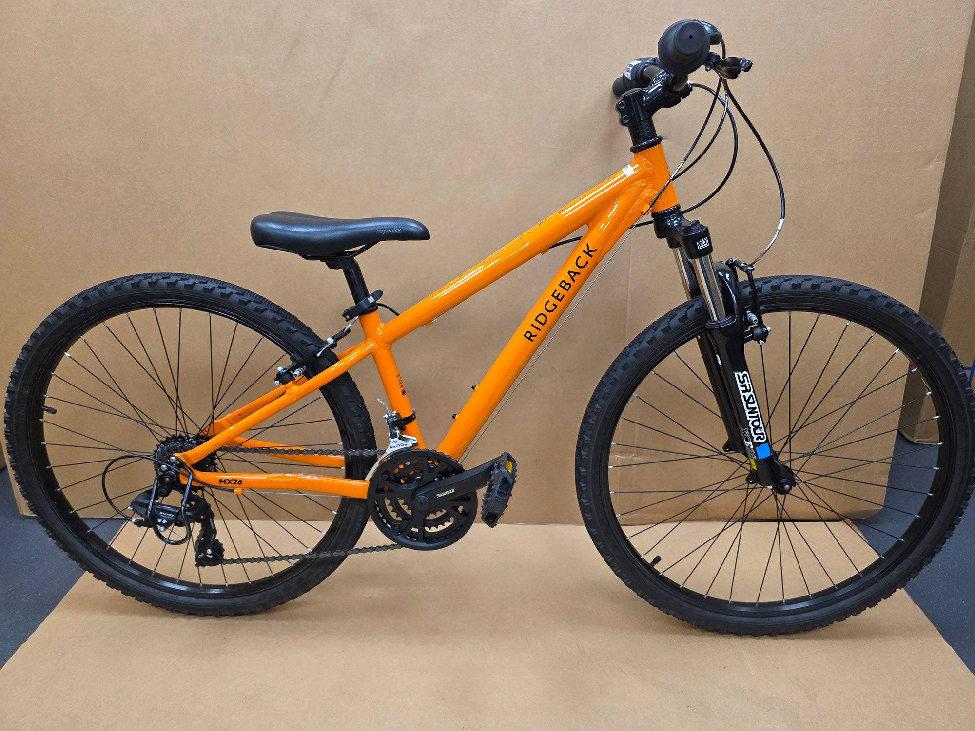 Ridgeback Kids MX26 demo bicycle with a durable 26-inch frame, suitable for children, featuring sturdy design and colorful accents.