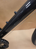 Grey Ridgeback Kids Dimension 26 bicycle for young riders, showing the durable frame and 26-inch wheels in a natural outdoor setting.