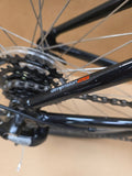 Grey Ridgeback Kids Dimension 26 bike with sturdy frame and tires, designed for young riders, shown in a close-up shot.