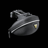 Topeak Propack lightweight bike seat pack with quick release strap and reflective piping, mounted on a bike saddle.
