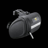 Topeak Sidekick Wedge Pack bike seat bag with semi-rigid design and reflective strip, mounted on bicycle saddle.