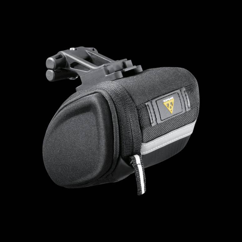 Topeak Sidekick Wedge Pack bike seat bag with semi-rigid design and reflective strip, mounted under bike saddle for accessories.