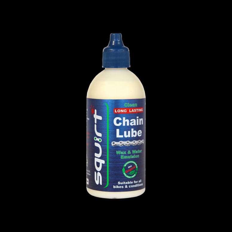 Squirt Maintenance Chain Lube by Squirt, eco-friendly bicycle chain lubricant in a workshop setting, showing the lubricant bottle.