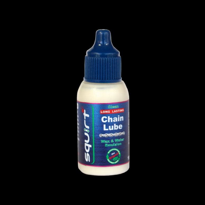 Squirt Maintenance Chain Lube by Squirt, eco-friendly bicycle chain lubricant, shown in a workshop setting.