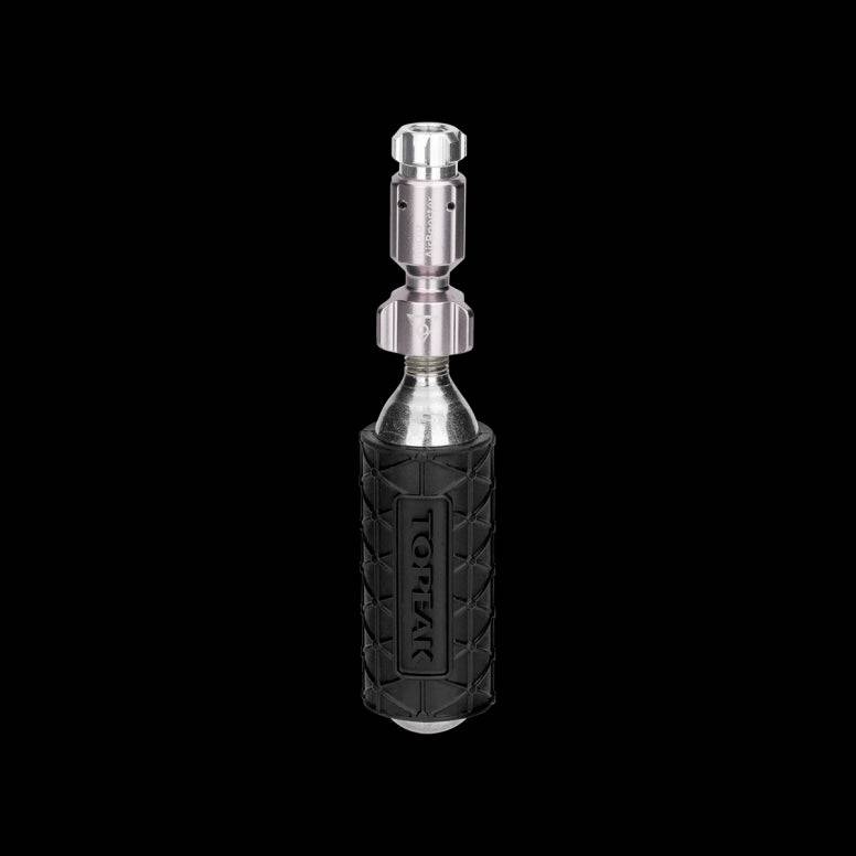 Topeak Micro Airbooster CO2 inflator with cartridge for Presta and Schrader valves, compact bike tire inflator accessory.