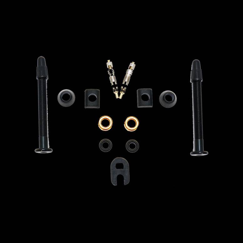 Orange Seal Versa-Valves tubeless valve kit with interchangeable grommets and removable cores, bicycle wheel component for tubeless setups.