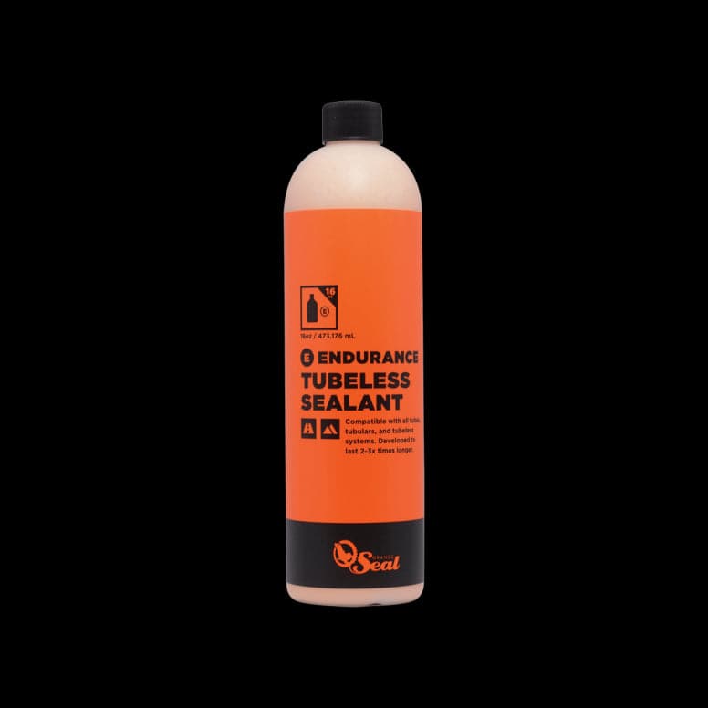 Orange Seal Endurance tubeless sealant in a container, designed for puncture protection and cold weather cycling applications.