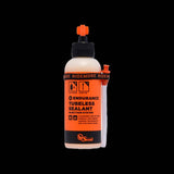 Orange Seal Endurance tubeless sealant for puncture protection and cold weather, shown in a container suitable for bike tires.