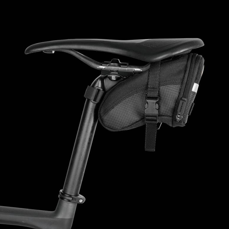 Topeak Aero Wedge Strap Mount bike seat pack with pump holder and reflective strips, designed for secure cycling accessory storage.