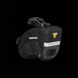 Topeak Aero Wedge Quickclick bike seat pack with pump holder and reflective strip attached to a bicycle seat.