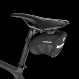 Topeak Aero Wedge Quickclick bike seat pack with pump holder and reflective strip, mounted under bike saddle for accessories storage.