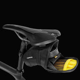 Topeak Aero Wedge Quickclick bike seat pack with pump holder and reflective strip attached to saddle for cycling accessories.