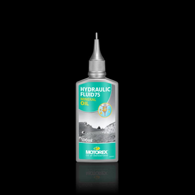 Motorex Hydraulic Fluid 75 mineral oil for bicycle hydraulic brake systems, workshop use, in a clear container.