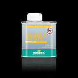 Motorex Hydraulic Fluid 75 mineral oil for bicycle hydraulic brake systems, shown in a workshop setting.