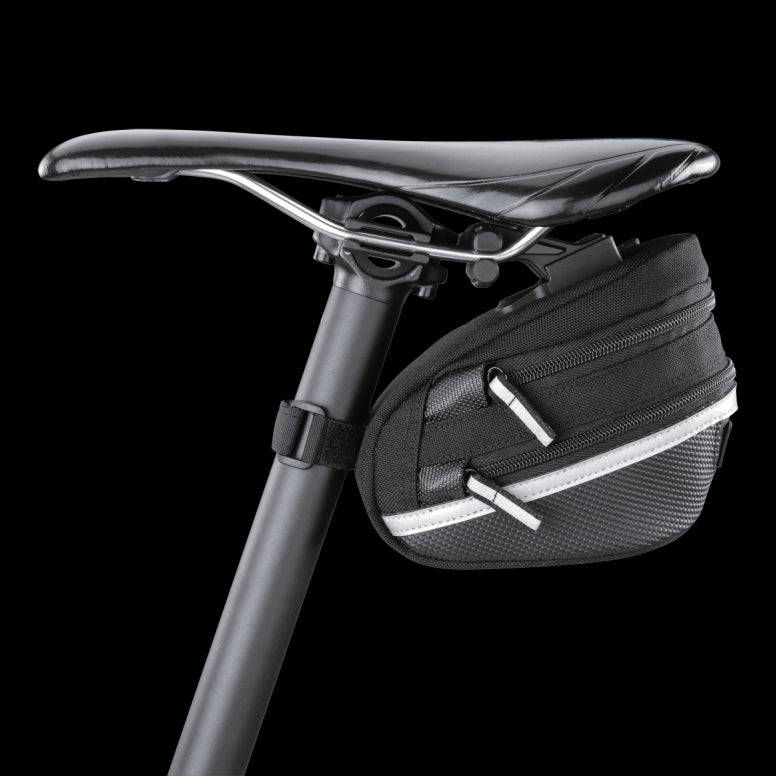 Topeak Wedge II Black Micro Bike Seat Pack with quick release mount and reflective strips attached to a bicycle saddle.