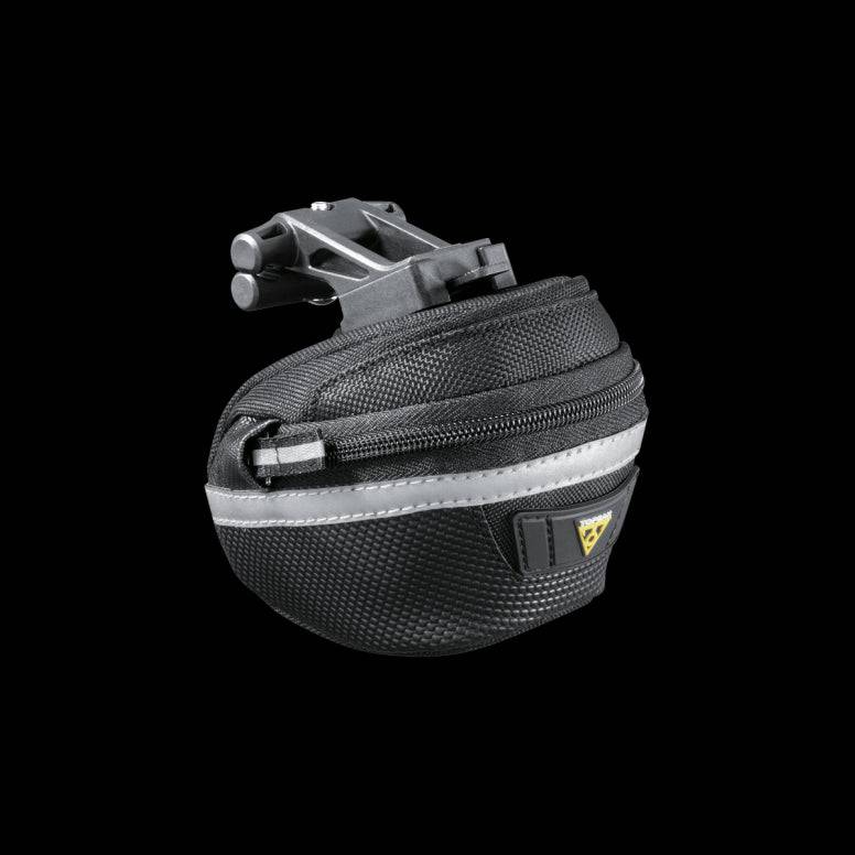 Topeak Wedge II Black Micro Bike Seat Pack with quick release mount and reflective strips attached to a bike saddle.