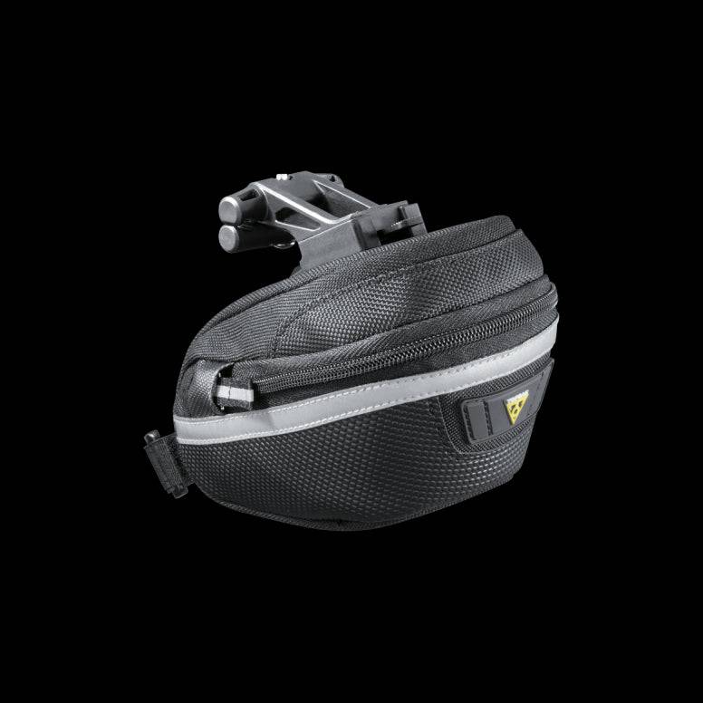 Topeak Wedge II Black Micro Bike Seat Pack with quick release mount and reflective strips on a bicycle saddle.
