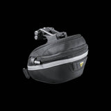 Topeak Wedge II Black Micro Bike Seat Pack with quick release mount and reflective strips on a bicycle saddle.