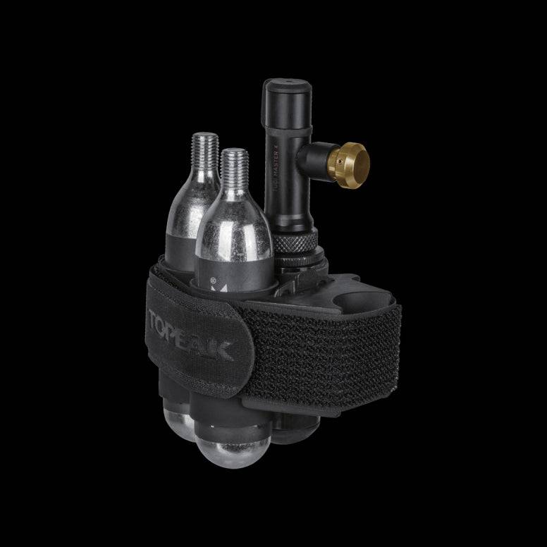 Topeak Tubi Master X 2-in-1 tubeless tyre repair and CO2 inflator kit for bike workshop use, featuring repair tools and inflator.