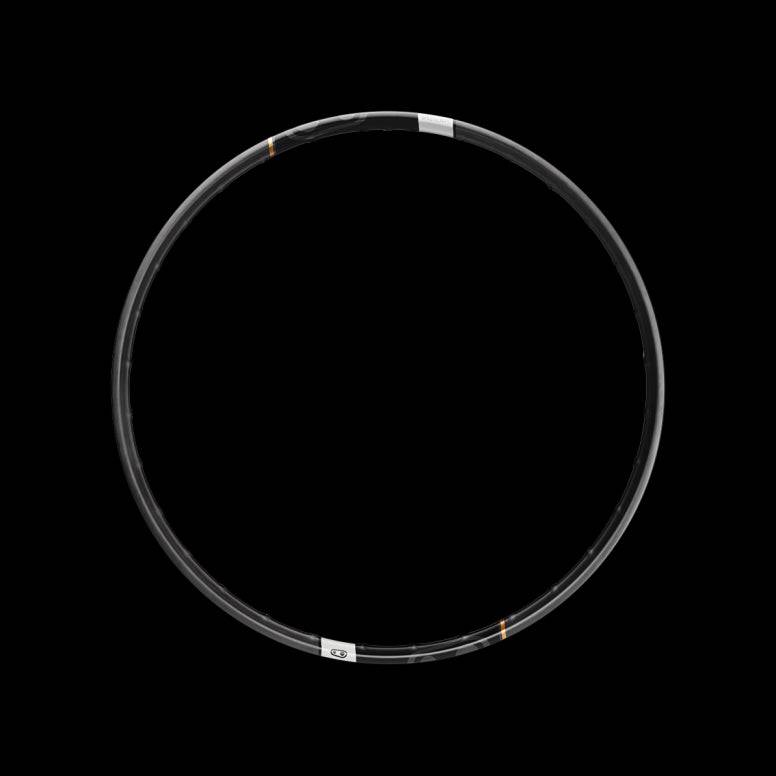 Crankbrothers Synthesis DH Carbon downhill biking rim, close-up of lightweight, durable alloy wheel component for mountain biking.
