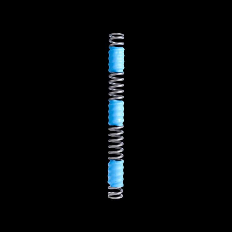 Cane Creek Helm fork main spring replacement and accessories for suspension performance, shown in a close-up image.