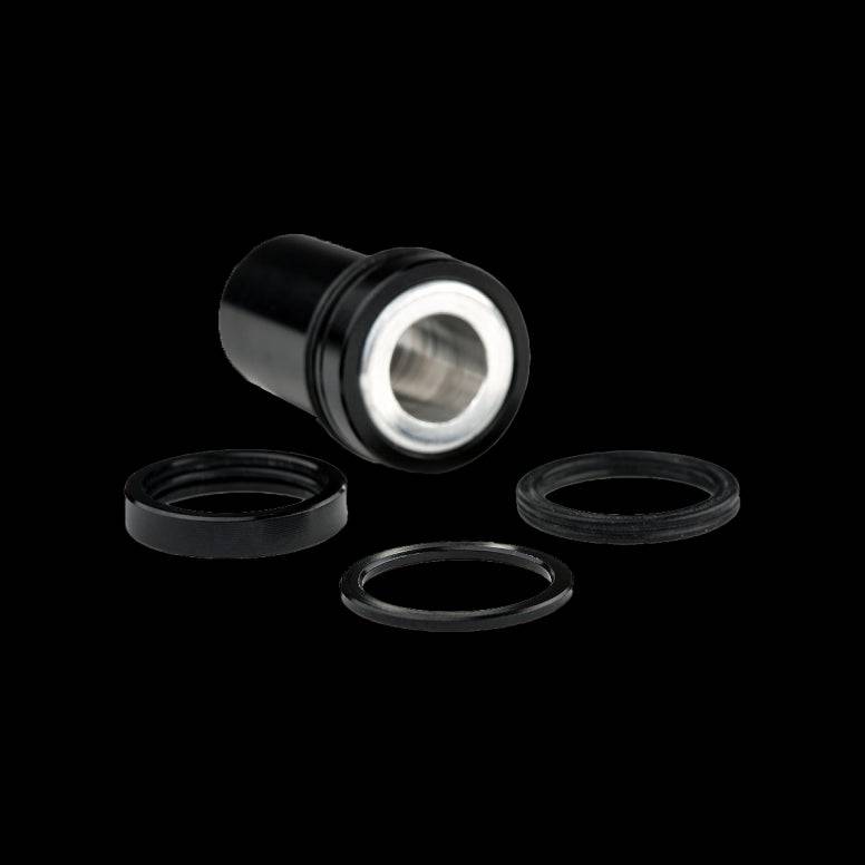 Cane Creek Double Barrel damper mounting hardware for rear shock, including components and accessories in black.