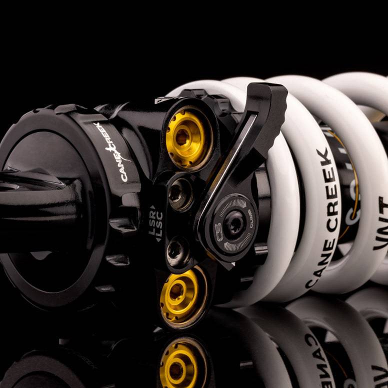 Cane Creek DBcoil IL G2 rear shock with four-way adjustability and climb switch, showcasing its coil spring design and adjustment controls.