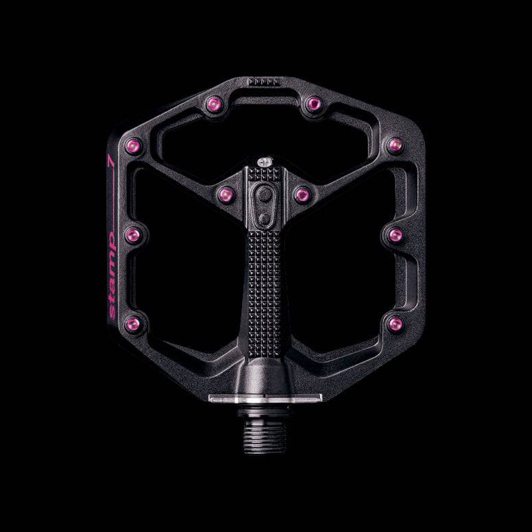 Crank Brothers Stamp 7 black and pink flat MTB pedal with adjustable pins, lightweight bike component for mountain biking.