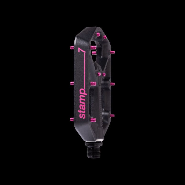 Crank Brothers Stamp 7 black and pink flat MTB pedal with adjustable pins, durable component for mountain biking.