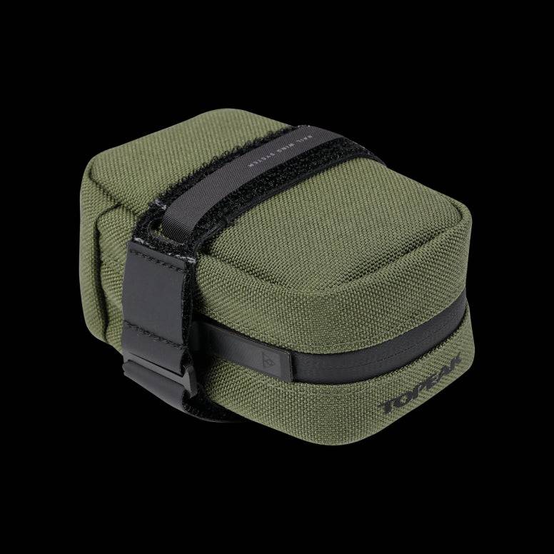 Topeak Elementa seatbag attached to a bike saddle, compact storage for tools and inner tubes, outdoor cycling accessories.