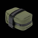 Topeak Elementa seatbag attached to a bike saddle, compact storage for tools and inner tubes, outdoor cycling accessories.